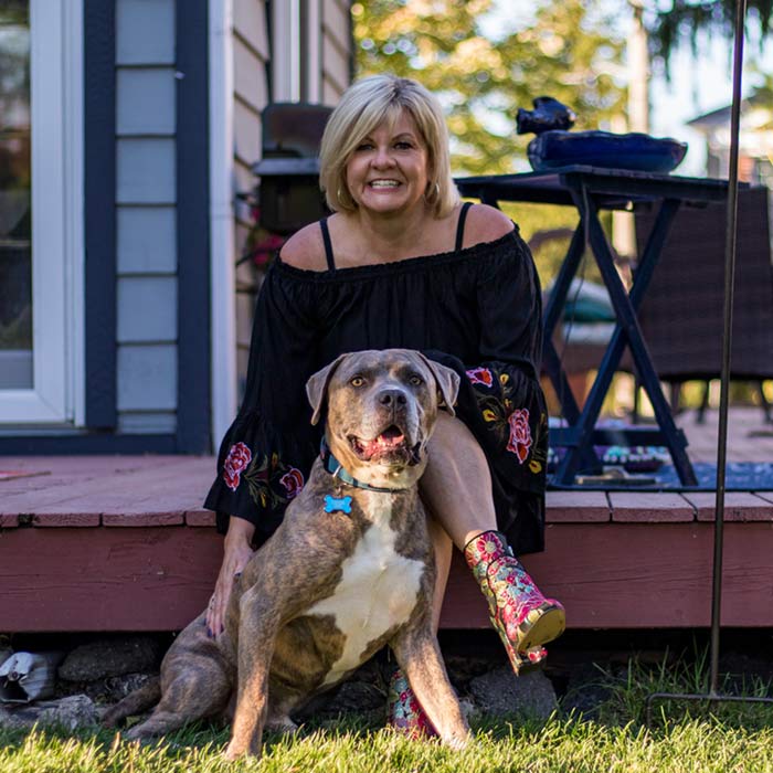 Bobbi Baehne sitting outside with her dog Kane